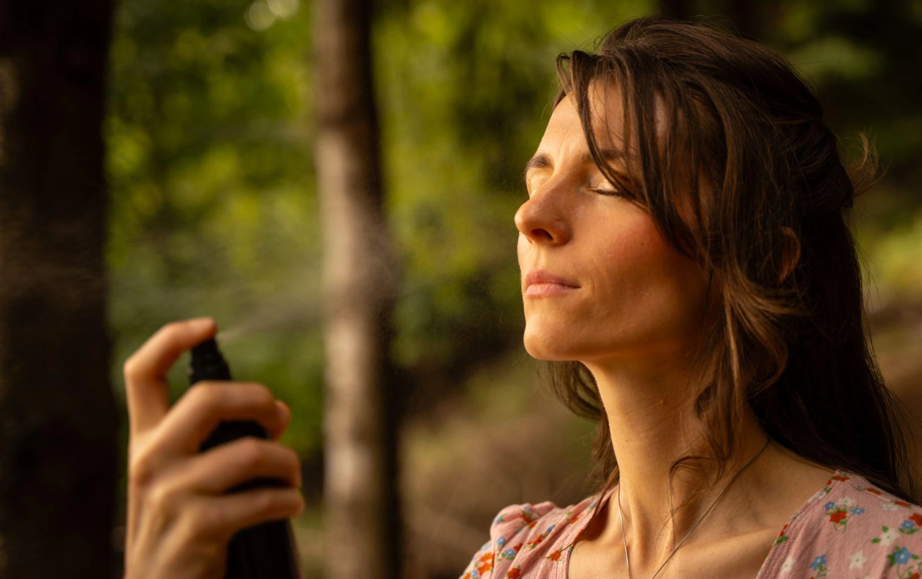 A woman using the fine mist in the forest